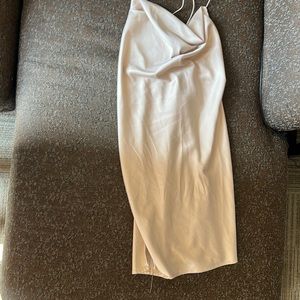 Short champagne colored dress with elastic crossed straps in back.